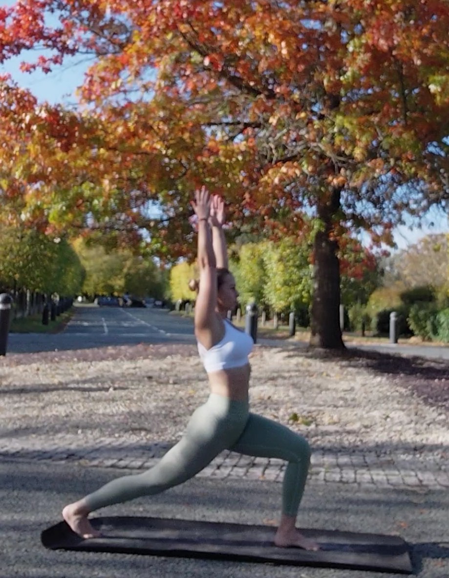 UlaTrains yoga teacher adjusting client’s posture during personalised private yoga in London