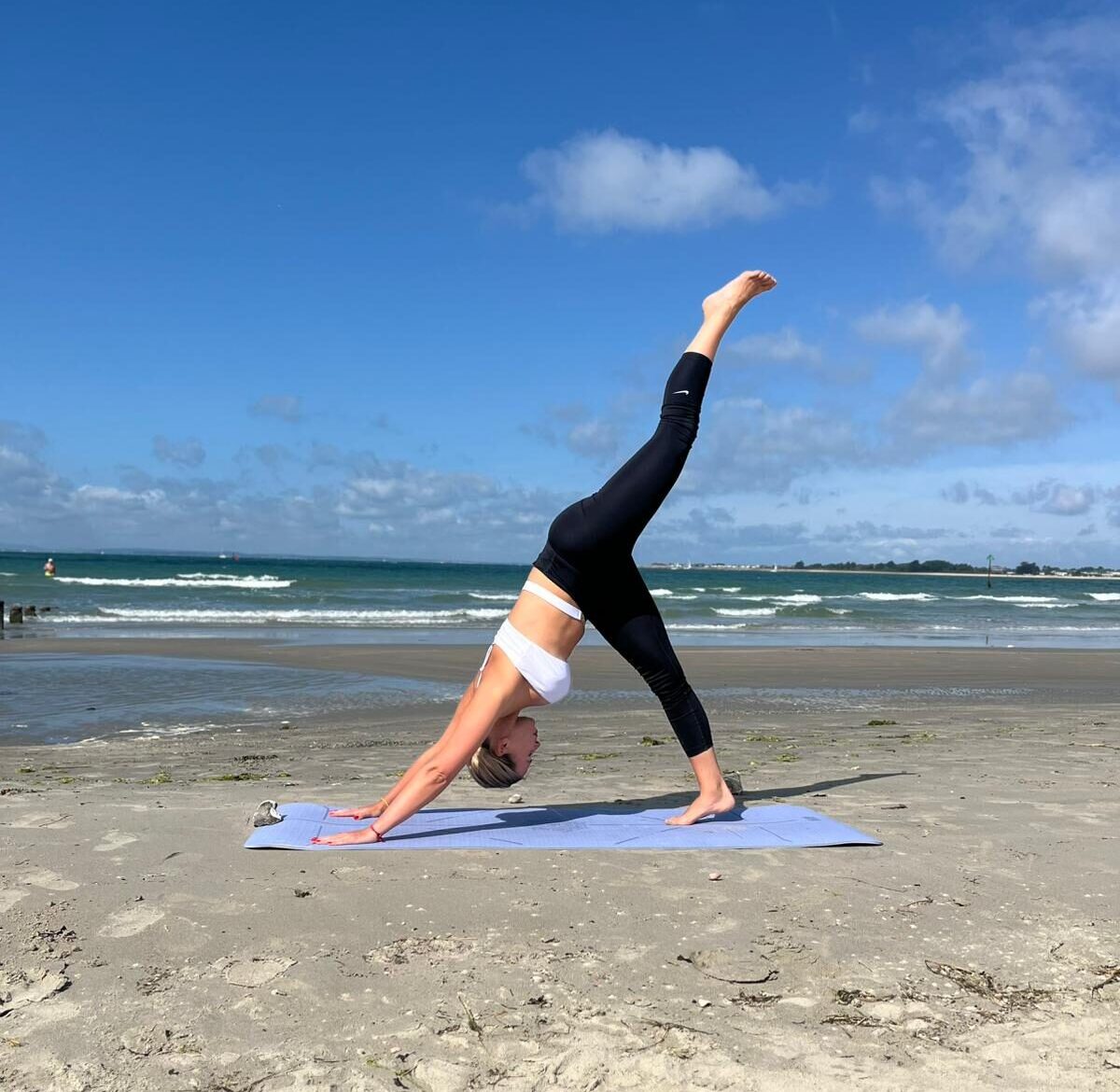 Corporate yoga London — UlaTrains leading lunchtime stretches for an office wellbeing session.