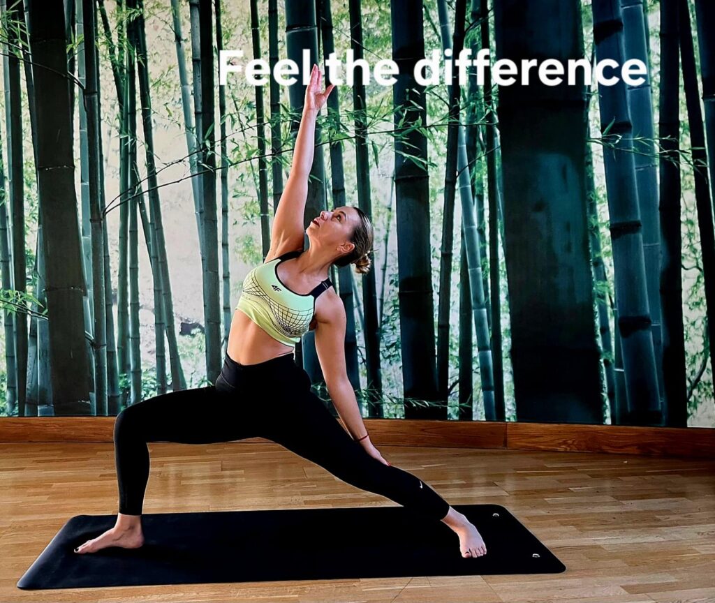 UlaTrains yoga teacher guiding a small corporate group through mindful breathing